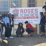 group in front of Roses in Concrete Community School