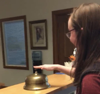 student ringing desk bell