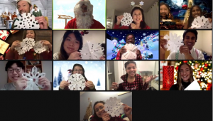 Screenshot of CCF’s Christmas party on Zoom with everyone holding paper snowflakes