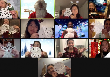 Screenshot of CCF’s Christmas party on Zoom with everyone holding paper snowflakes