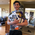Bryce holding a bunch of college brochures