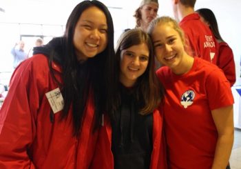Nelia with 2 other orientation leaders, all in red