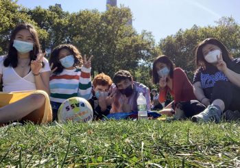 Lucy & 4 friends on grass with masks