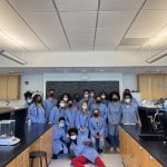 group of students in lab coats in lab