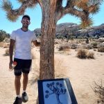 Bilal in front of Joshua Tree with explanatory sign
