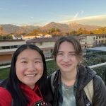 Emma and a friend on a rooftop with San Gabriel mountains backdrop