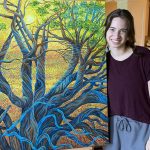 Emma Grace with a large piinting showing blue roots of tree