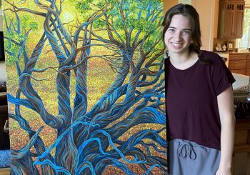 Emma Grace with a large piinting showing blue roots of tree