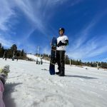 Bilal on slope holding snowboard